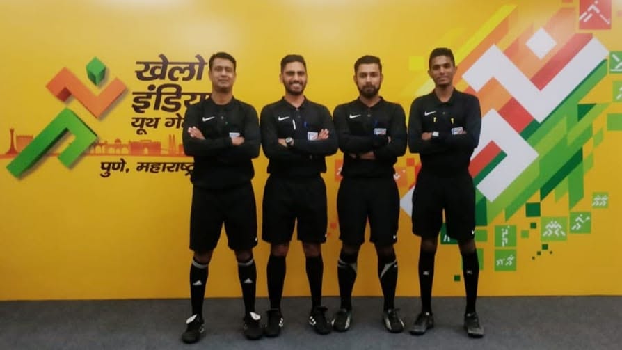 Praveen Pharasi with fellow football officials in front of a Khelo India Youth Games backdrop in Pune