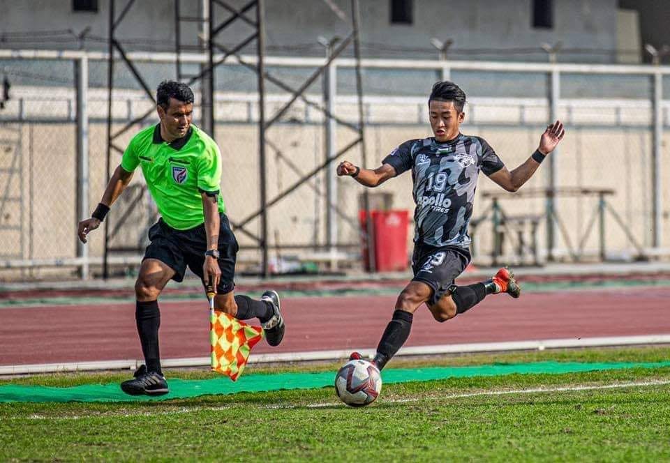Praveen Pharasi running the touchline with an assistant referee’s flag during a football match